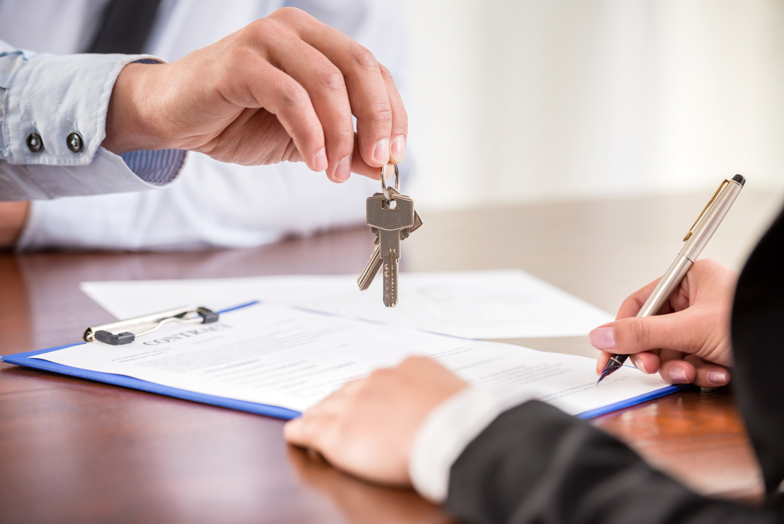 Realtor handing keys to a new homeowner